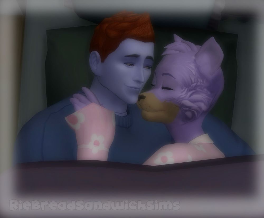 A screenshot of The Sims 4, two characters are laying in a bed together, on the left is a periwinkle colored humanoid robot with an orange faux hawk. On his right is a lavender cat wearing pink pajamas with a white flower pattern.

She is resting her head on his shoulder, nuzzling close to him with her eyes closed. He looks at her with a tender smile.


There is a dreamy glow effect on the screenshot, indicating this is a dream of the cat.