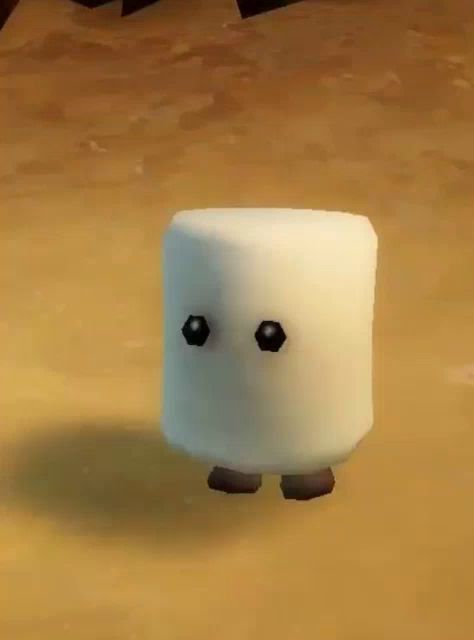 a marshmallow with a face and legs is walking on the ground in a video game .