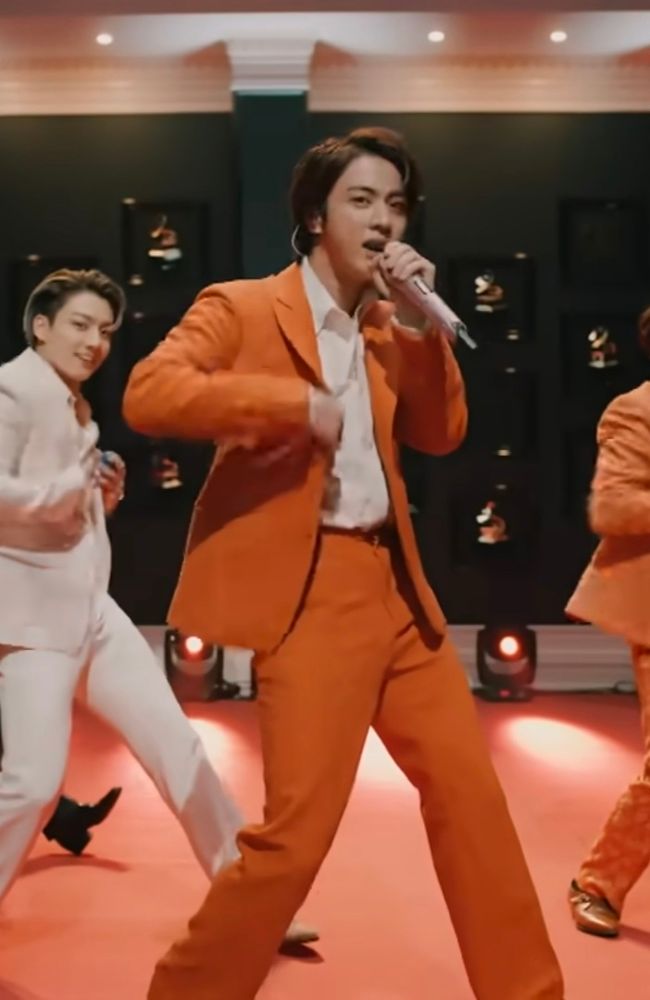 Looking stunning in orange, Jin caught the eye of many muggles who referred to him as the Orange Suit Guy.