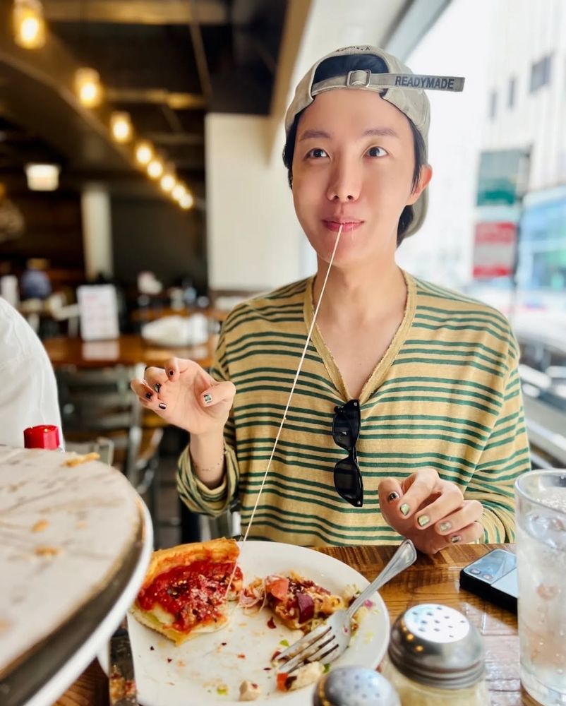 An adorable J-Hope is so adorable that his pizza refuses to let go. 