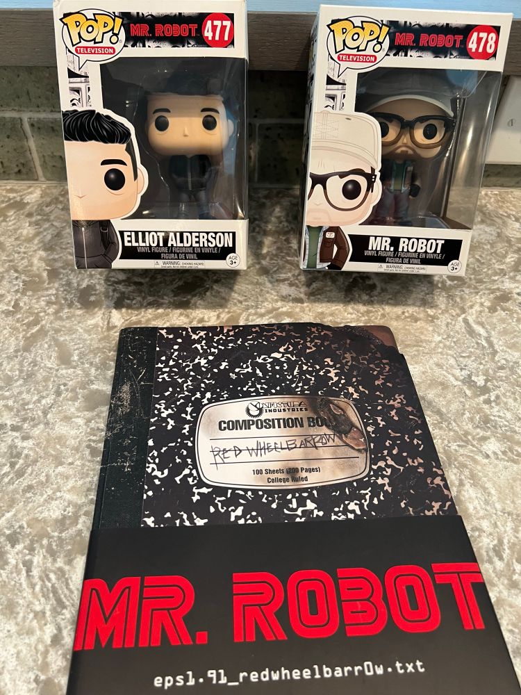 Two Mr Robot funko pops - Elliot Anderson and Mr. Robot - and a Mr. Robot Red Wheelbarrow notebook