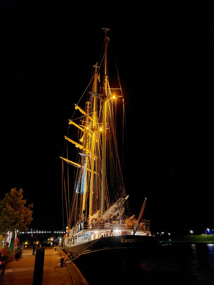 Ein angeleuchtetes Segelschiff.