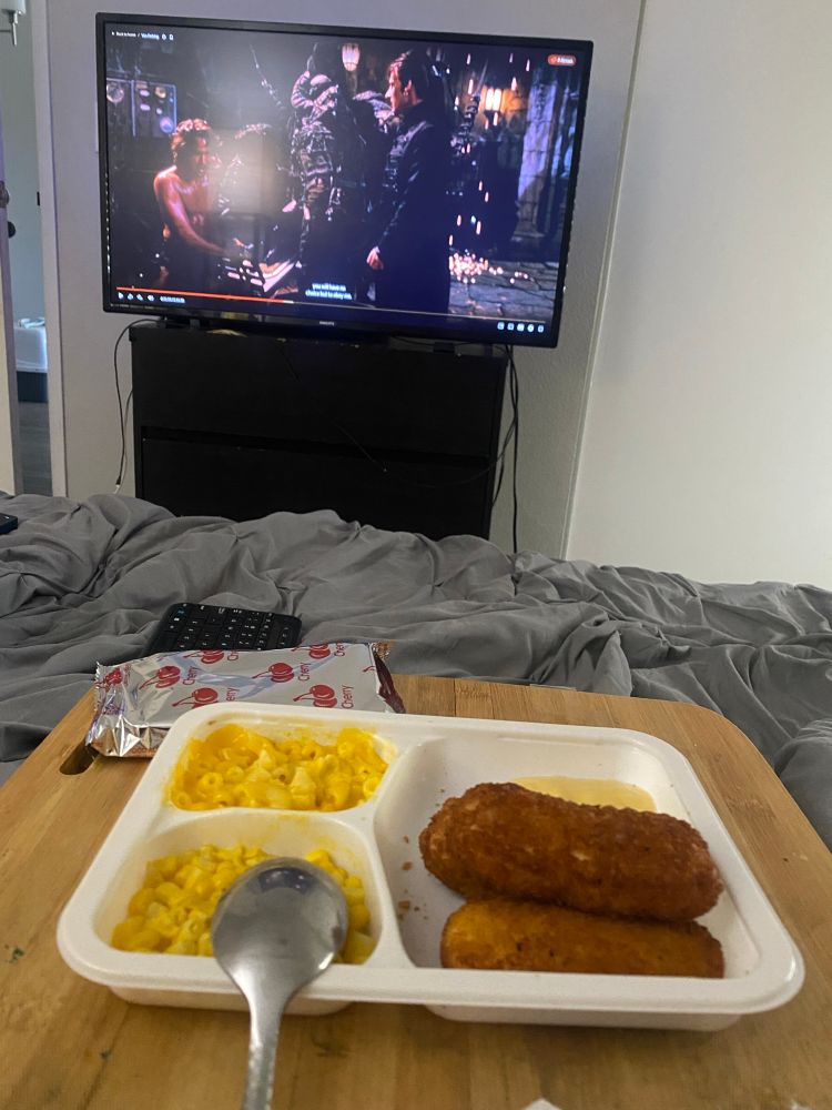 a banquet chicken strip microwave dinner with a bag of cherry pop tarts next to it. i am also watching Van Helsing in the background 