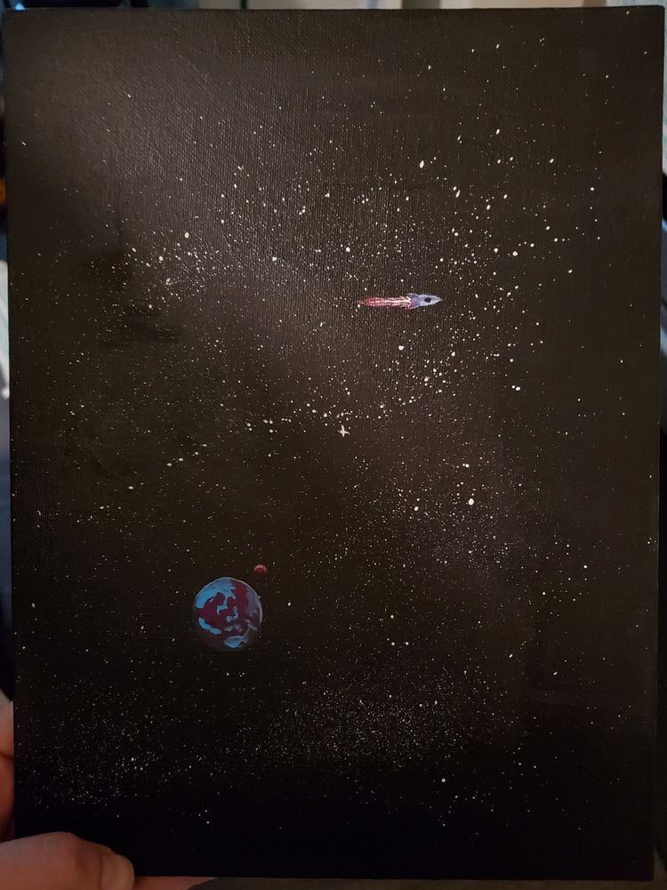 Painting held in hand, showing a space ship and planet with a small moon on a back drop of starry space