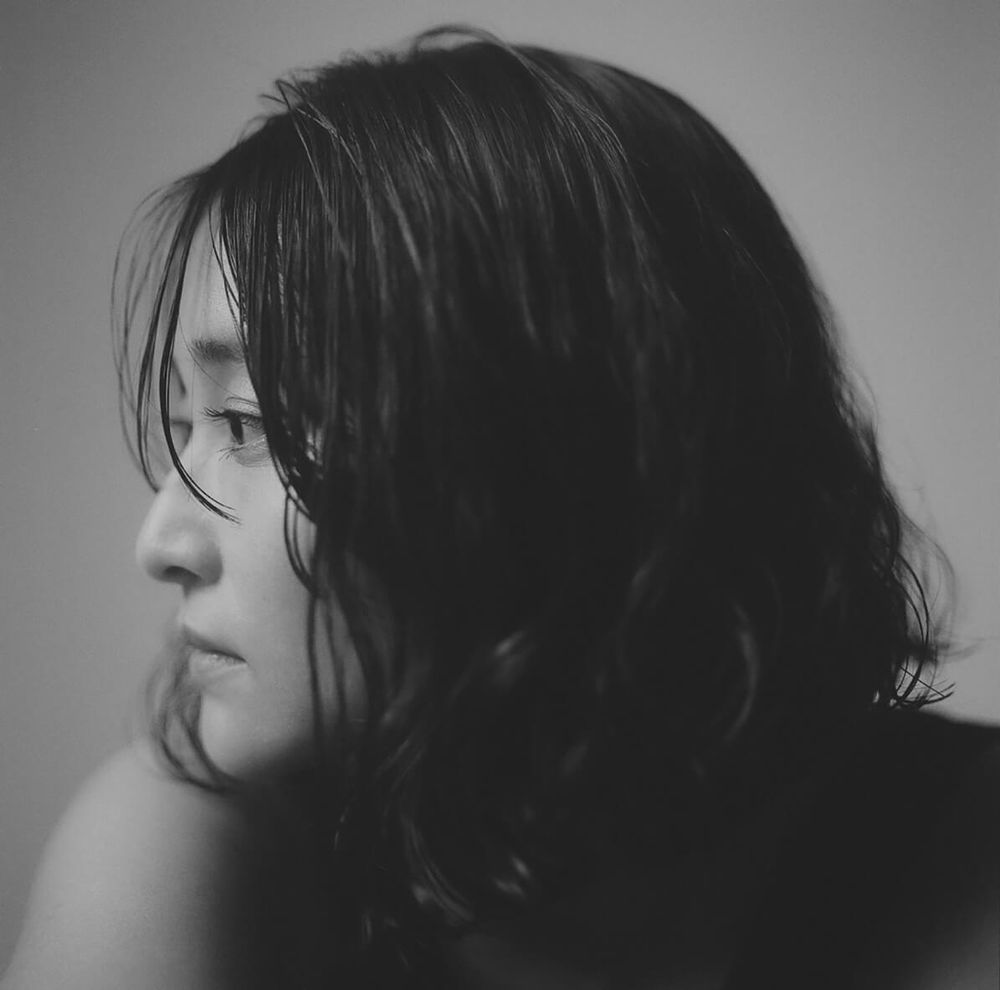 Profile side picture of Ayacho. All pictured are B&W. shes rocking a layered bob haircut.