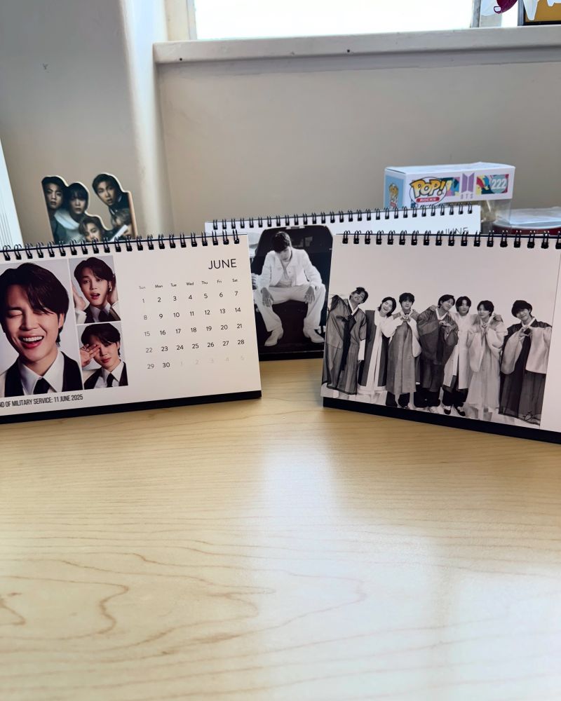 Photo of an office desk with BTS memorabilia 