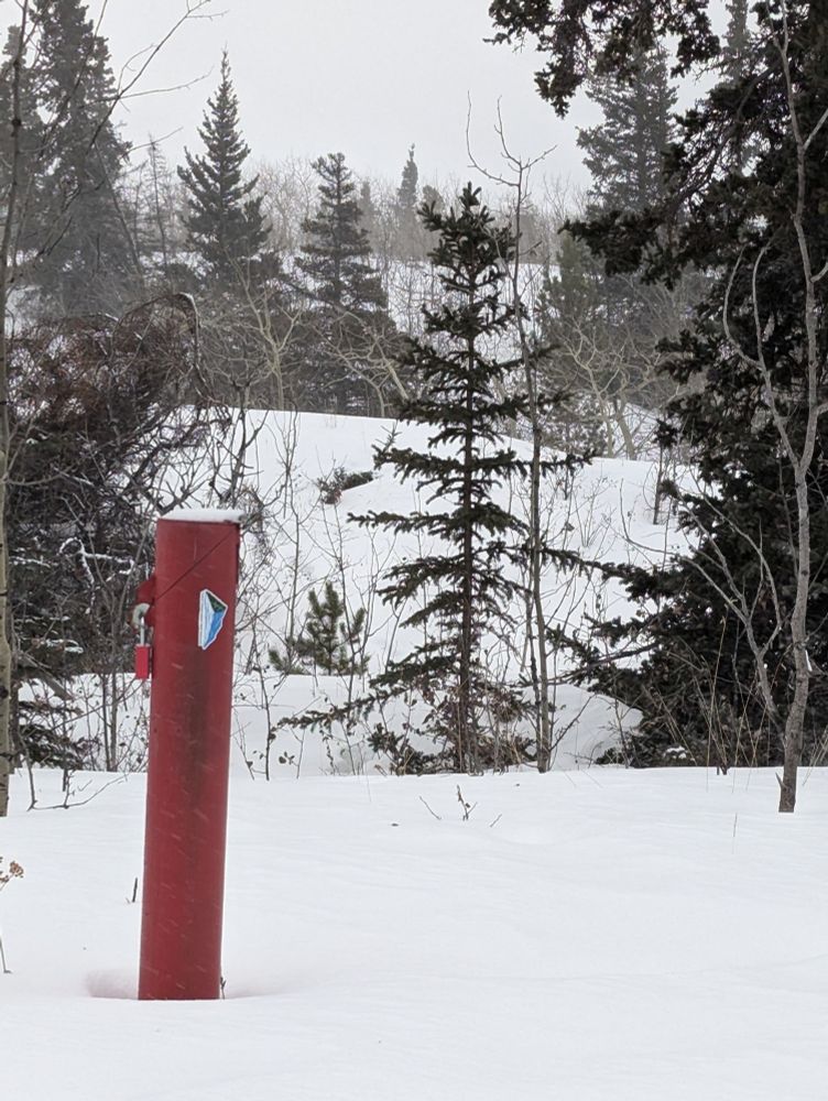 Groundwater well monument in snow.