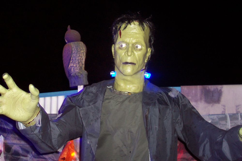 A life-sized Frankenstein animatronic with it's arms outstretched. 