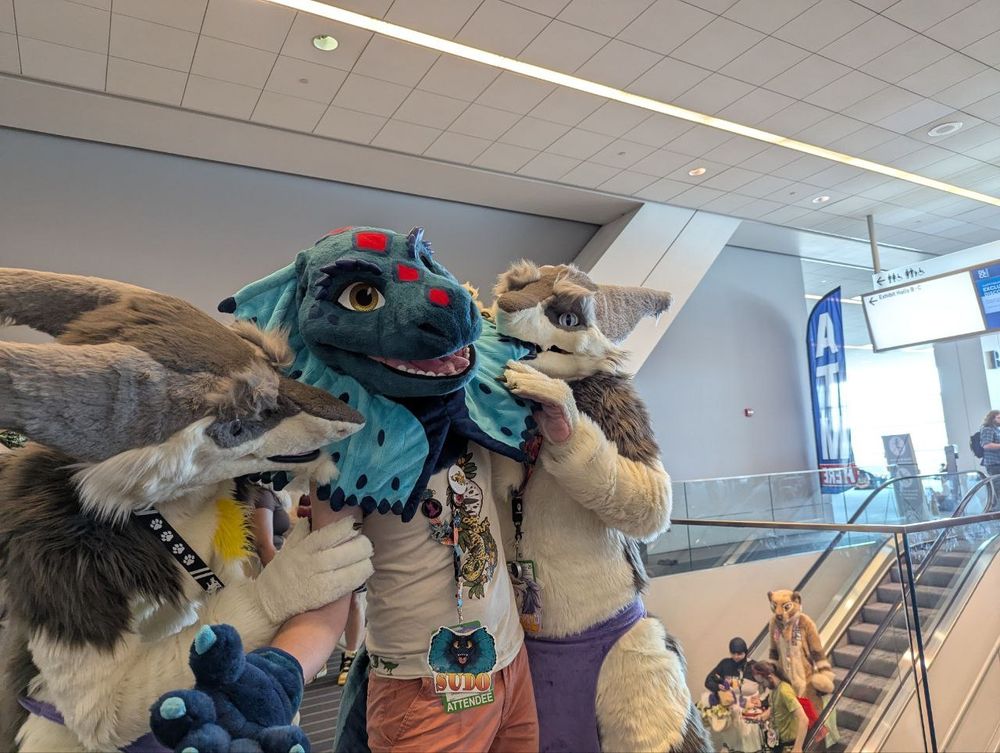 Double Kel teaming up on a cute frilled lizard, nomming on his crest and hugging him from both sides.