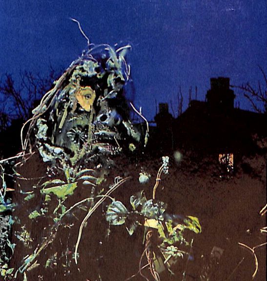 A plant monster taking a selfie with a haunted house.