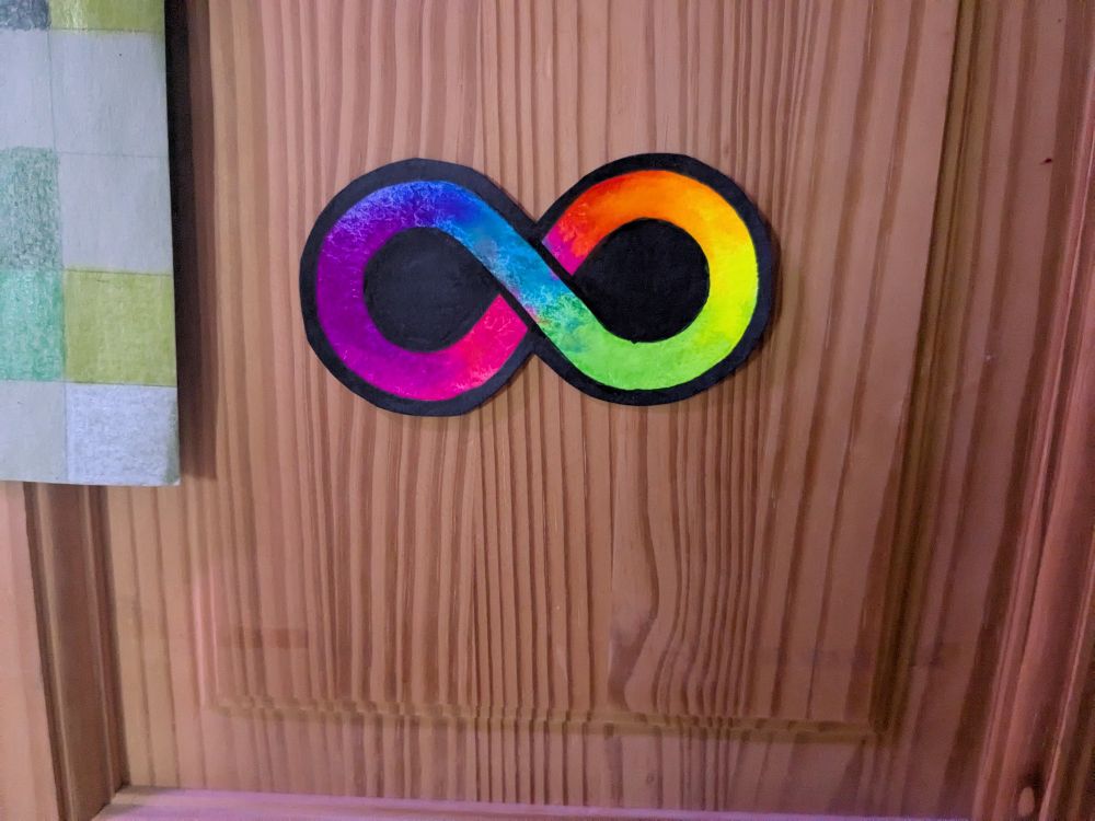 Neon rainbow infinity symbol, the symbol of autism acceptance.