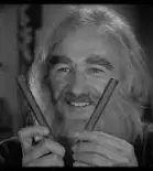 Still photo of a bearded Gene Hackman holding two cigars from the movie Young Frankenstein . 