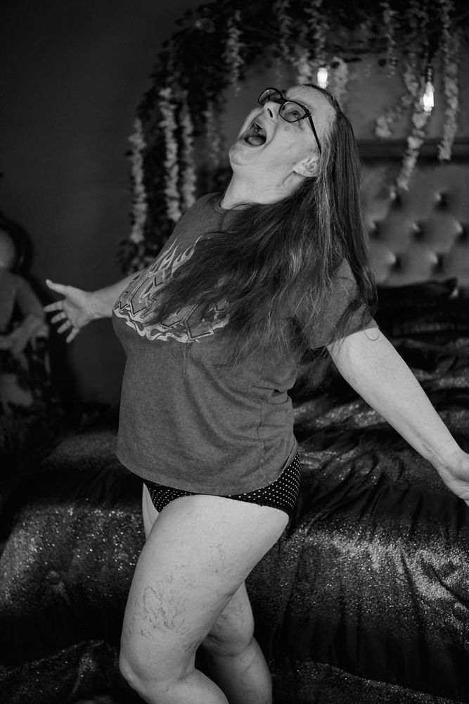 Black & White image of me standing with my arms wide, head tilted up and screaming. I'm wearing an AC/DC t-shirt and polka-dot panties