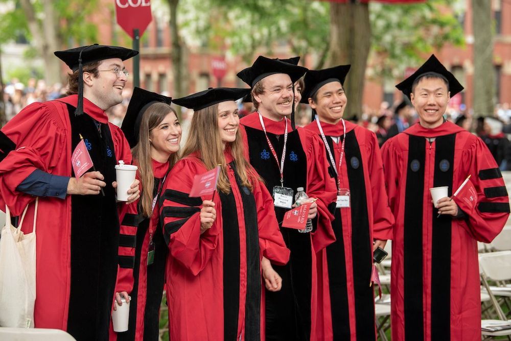 graduates smiling with flags