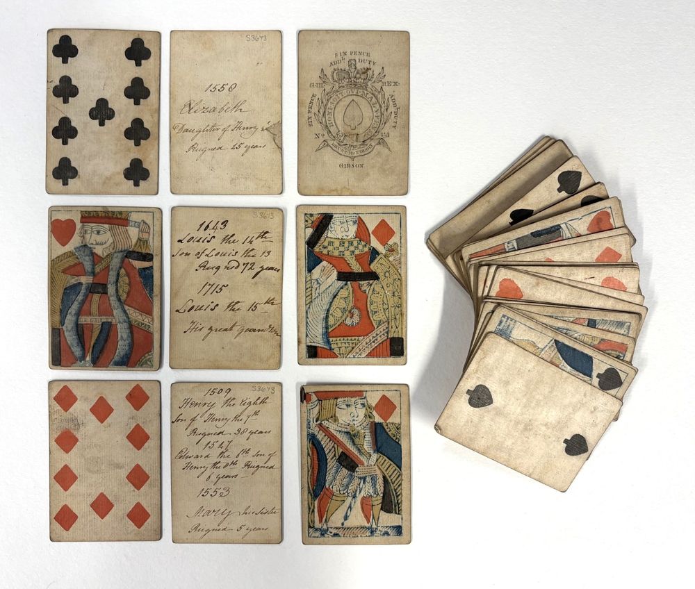 Playing cards with handwritten historical dates on the back 
