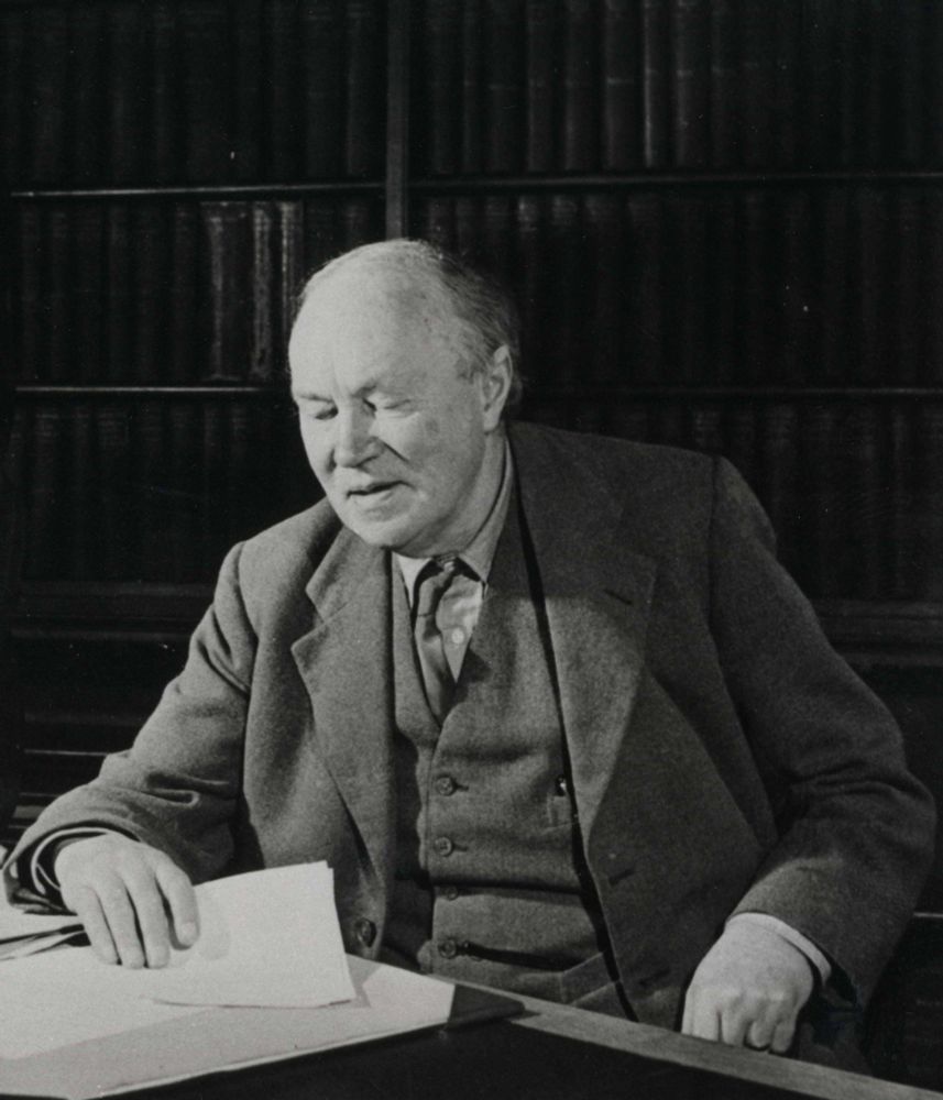 Alexander Dunlop Lindsay sitting at a desk at Keele.