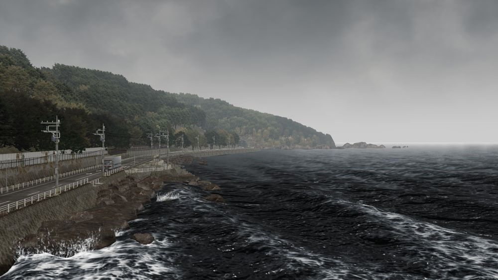 An scene shot in Infinite Wealth. A cloudy day with a lot ocean sitting on the bottom right half. On the left is island with trees and a car road.