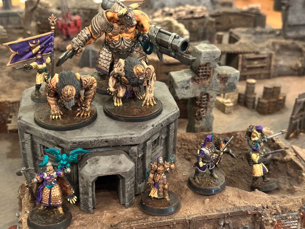 An Iron Sultanate warband posted atop a pillbox on the trenches. A Brazen Bull, two Lions of Jabir, four Azeb industry, a Jannisary, an Alchemist, and a captain. 