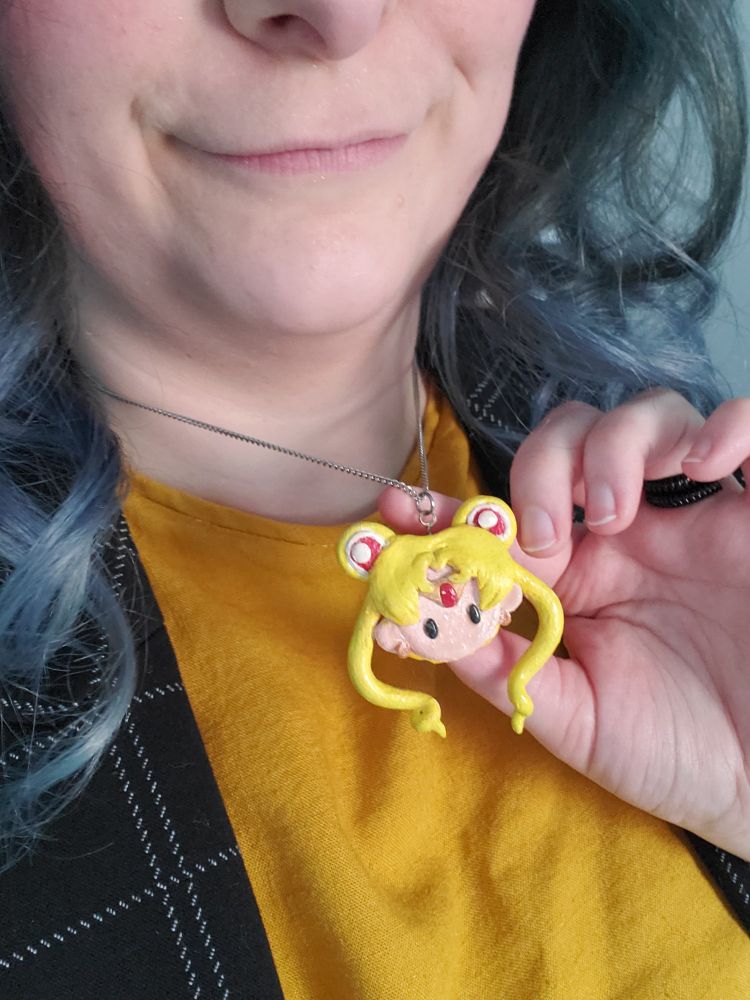 Elaine's necklace (a handmade clay charm of Sailor Moon's head. A birthday gift from a friend many years ago)