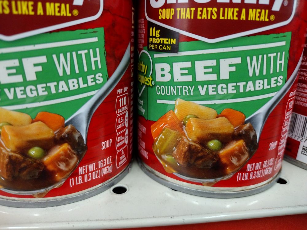 photo of canned soup. label reads "beef with country vegetables".