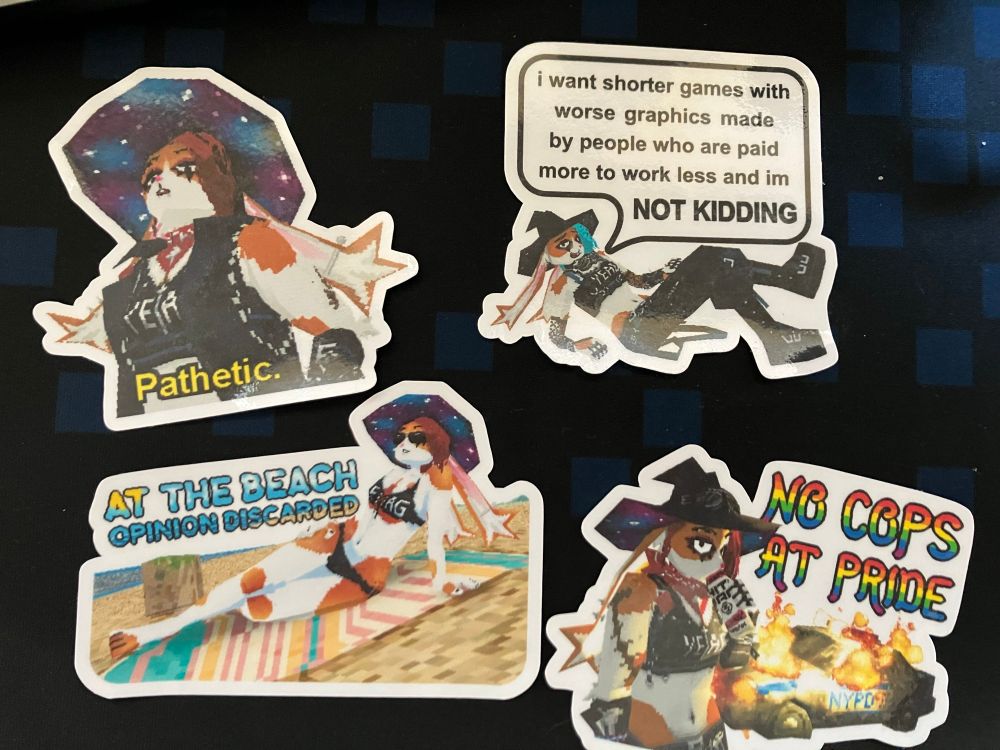 4 stickers made by b0tster, who is a super cool game dev you should follow. The top left sticker depicts her avatar (Bunlith, I think) from a low angle, staring down in disapproval. The caption reads, “Pathetic.” The top right sticker depicts her again, reclining in a “chill” pose, saying: “i want shorter games with worse graphics made by people who are paid more to do less and im NOT KIDDING”. The bottom left sticker is her in a bikini (and iconic witch hat, of course), on the beach, with the caption: “At the beach / Opinion discarded”. Lastly, the bottom right sticker is her drinking from a can in front of a flaming cop car, with the caption: “No Cops At Pride”. 