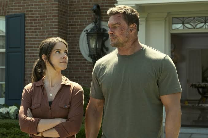 A picture of a Reacher, a big dude, next to a less big lady