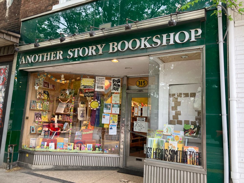 A picture of the front window of Another Story Bookshop on Roncesvalles. 
