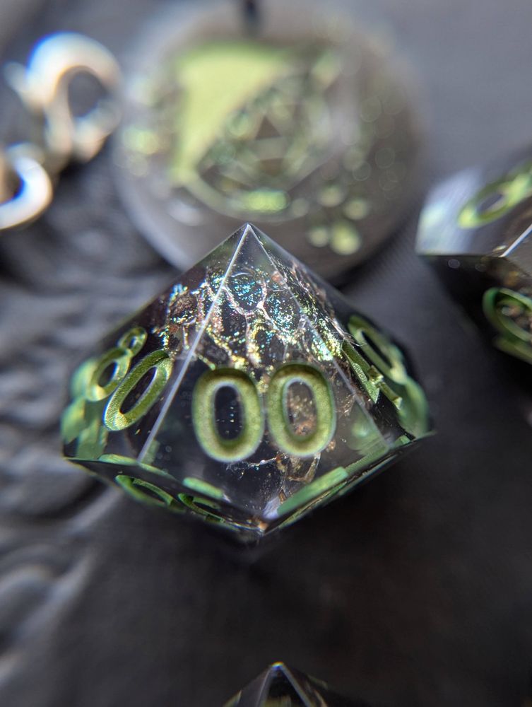 Handmade dice with snake shed painted gold, and metallic green numbers
