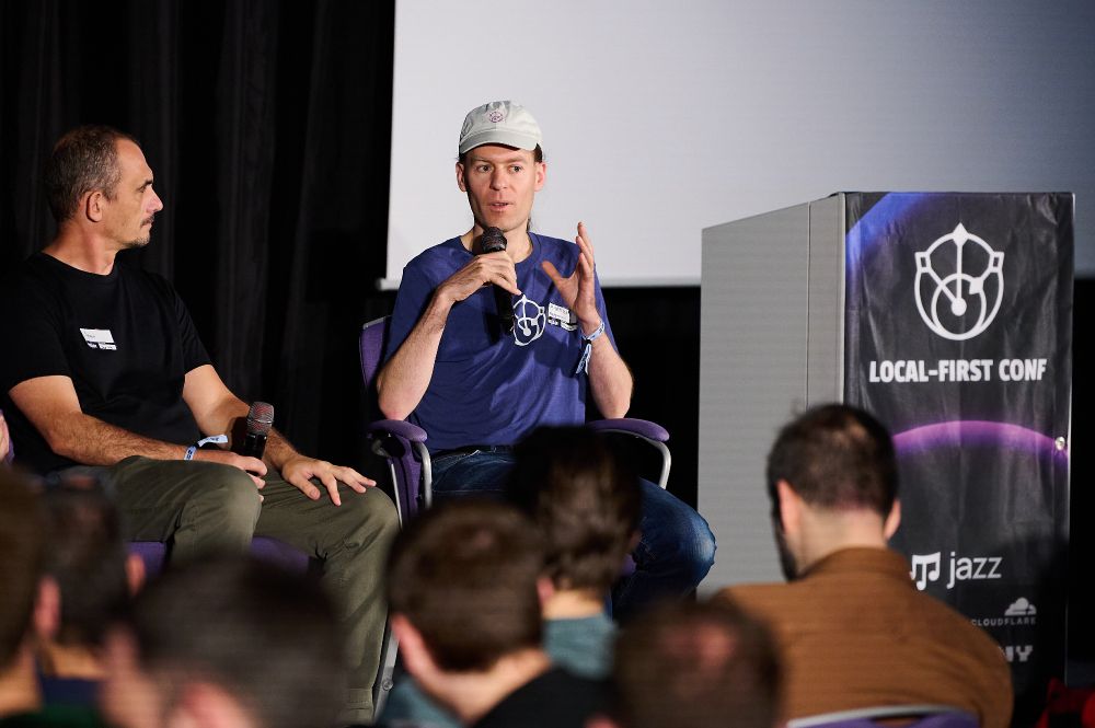 Me on stage speaking as part of a panel, sitting next to Aaron Boodman
