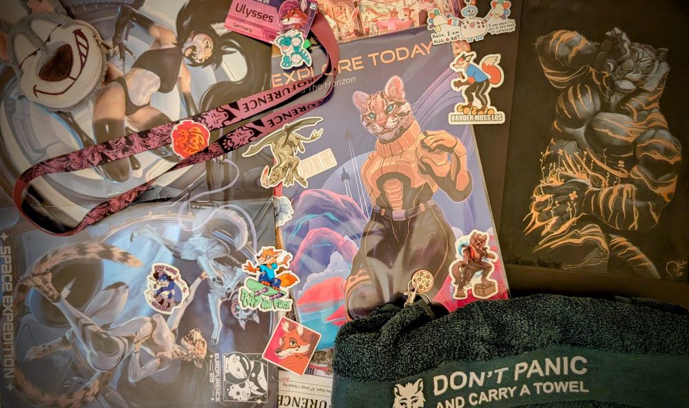 A collection of loot and memorabilia of this years Eurofurence, featuring the conbook cover art by Royz, digital print of a space-faring kitty and Thrive, a beautiful original artwork by AlectorFencer among others. 