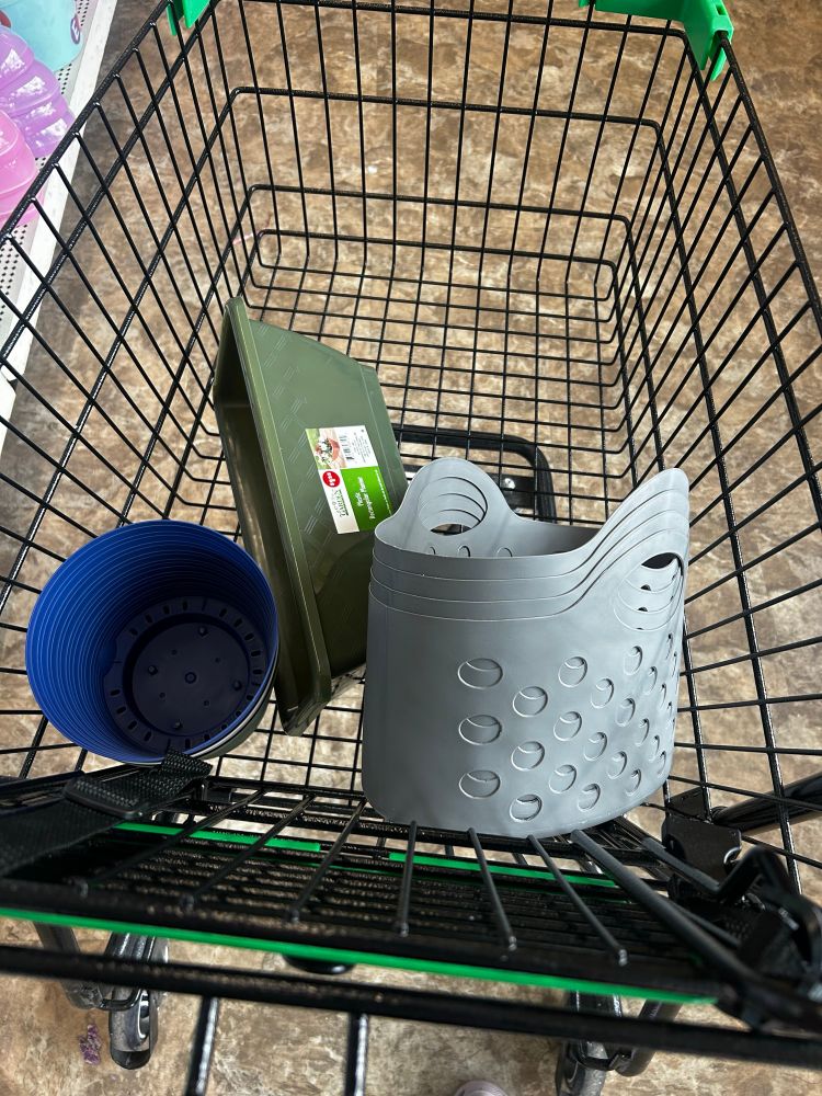 A wheeled container (shopping cart) contains various containers 