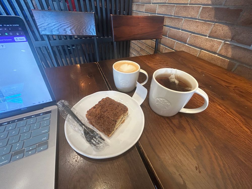 Picture of coffee cake, tea, and cortado in mugs. 