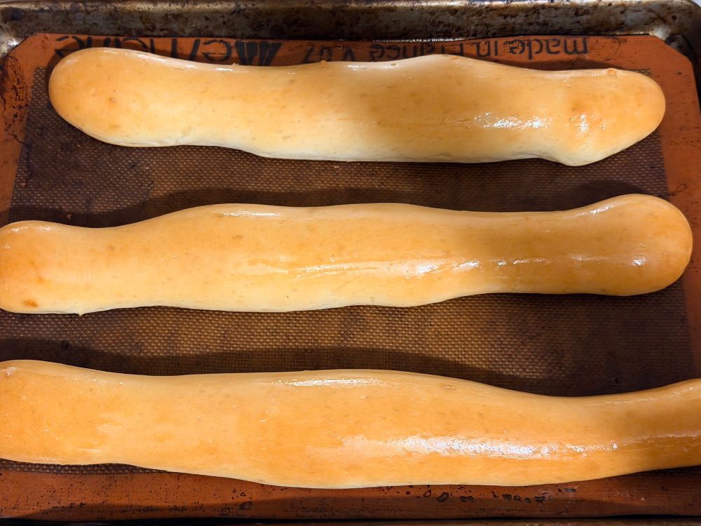 Skinny breads. They are oiled up and in suggestive shapes by virtue of the fact that my dough-shaping skills are not great 