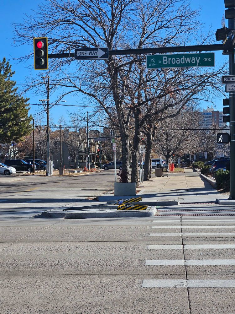 Picture taken of the Broadway bike lane signs at Broadway and Second in Denver knocked down on December 2nd.