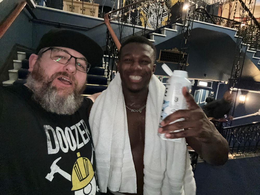 Alastair with a professional  wrestling athlete. 