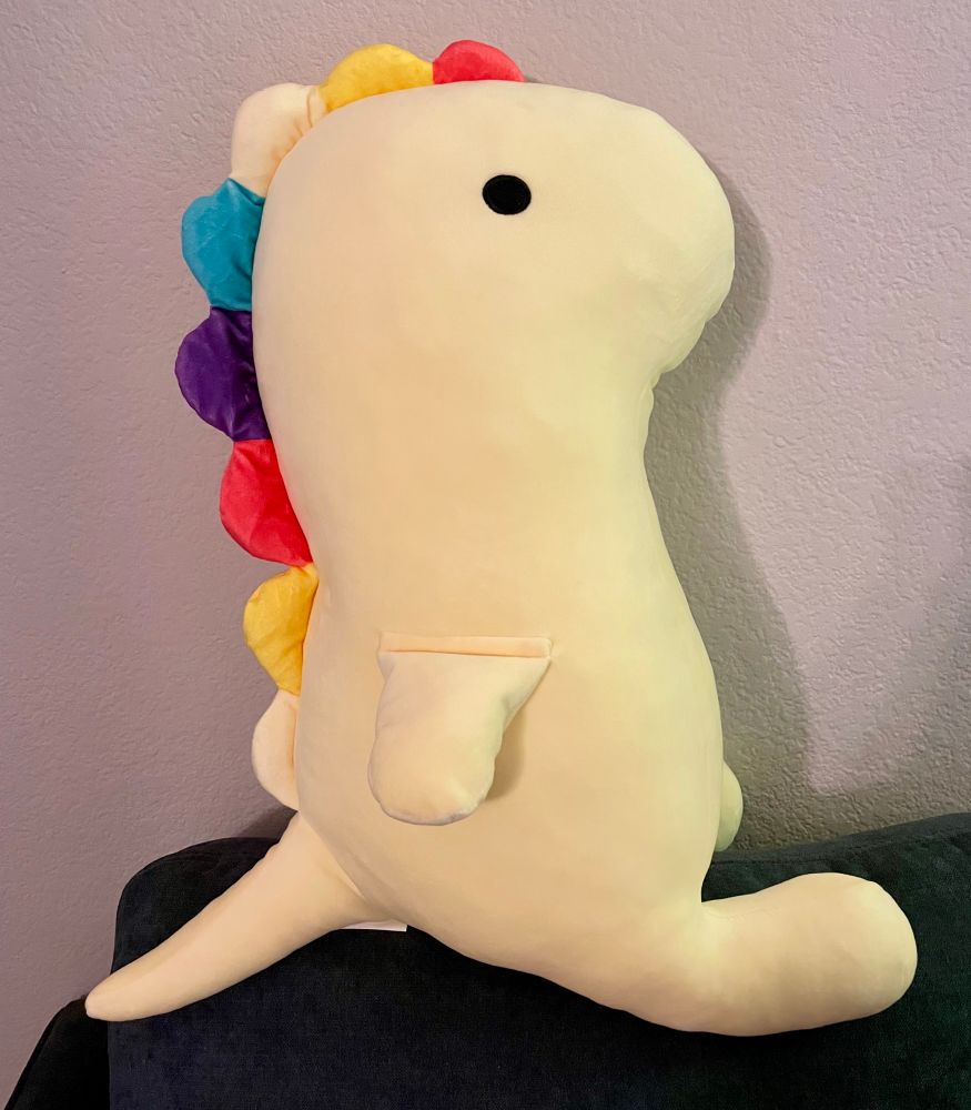 Daiso yellow dino plush with red, yellow, blue, purple spikes