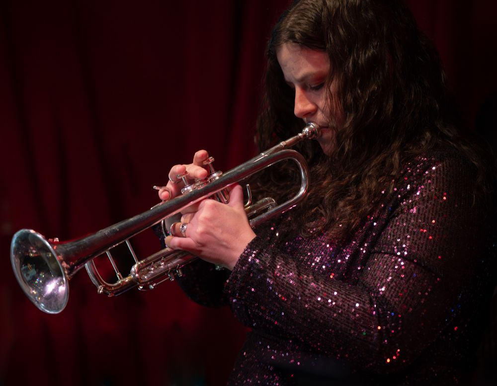 Trumpet player Anita in profile again, this time head bowed, praying to the jazz gods