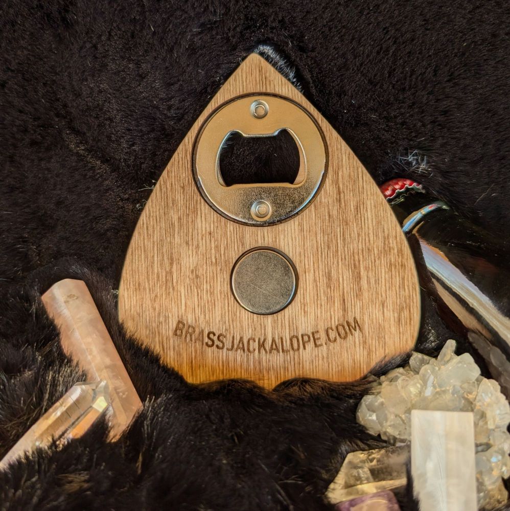 The back side of the bottle opener. It has a magnet and says brass jackalope.com
