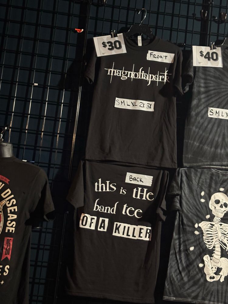 A t shirt, the front reading Magnolia Park in the Twilight font. The back reads “This is the band tee of a killer.”
