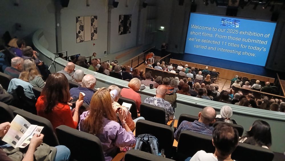 Aerial view of cinema audience with welcome screen