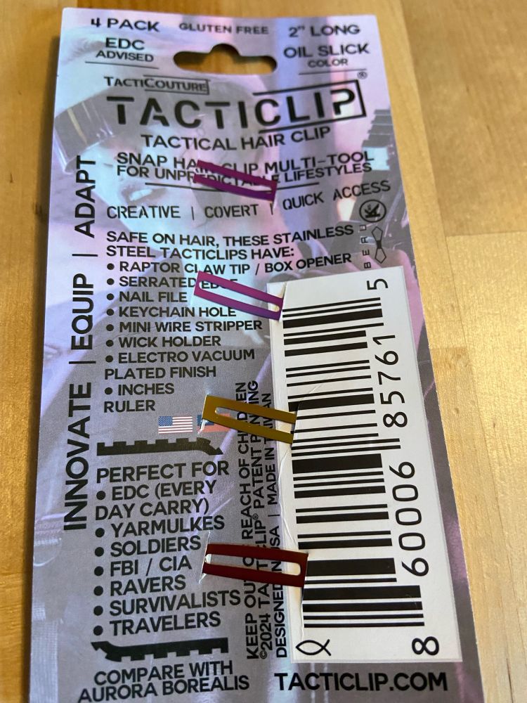 Back of package of TactiClip, a brand of hair clips for toxic masculine dudebros that are also outlandishly iridescent. 