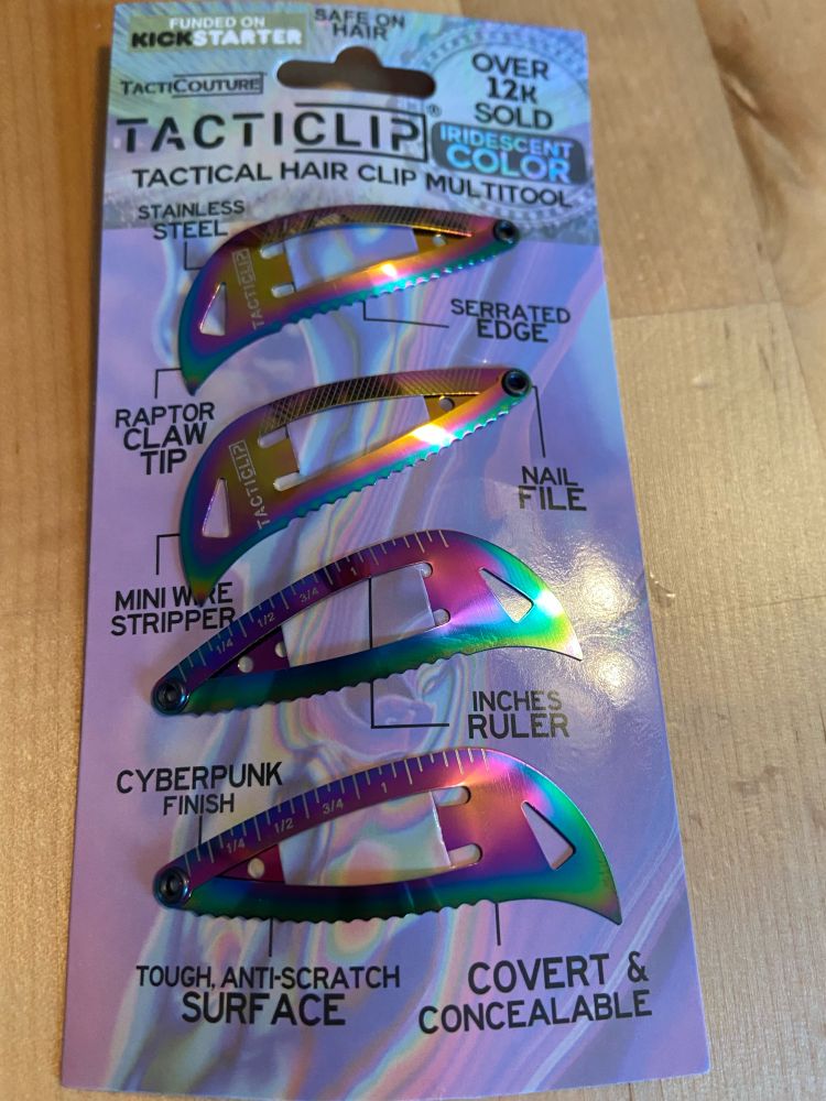 Front of package of TactiClip, a brand of hair clips for toxic masculine dudebros that are also outlandishly iridescent. 