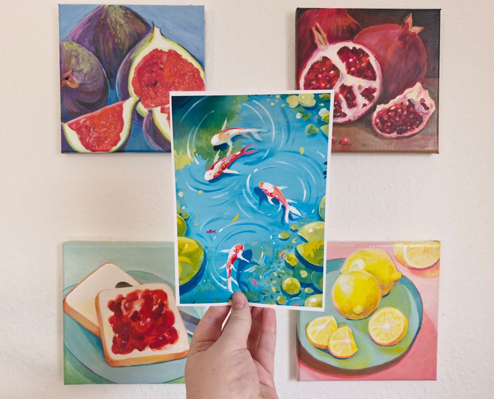 A print of a painting of koi fish swimming in a pond surrounded by lillypads 