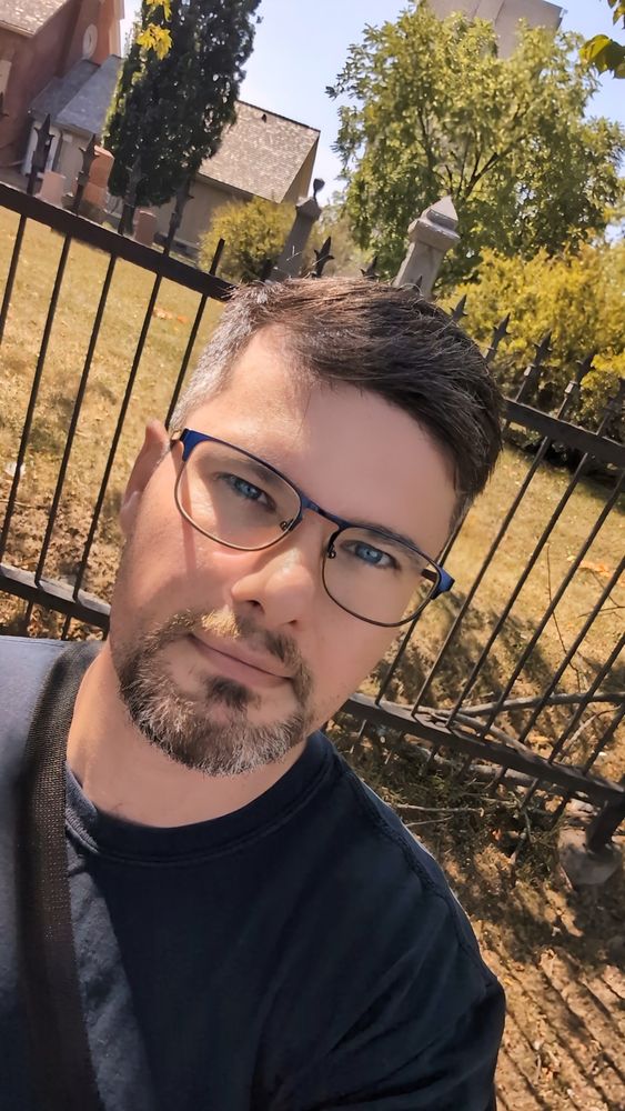 Sean just after getting a haircut. Walking past a historic church and graveyard in the autumn sun.