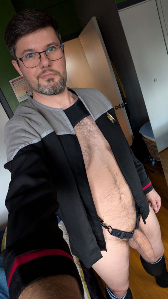 DS9 era jacket, and a black harness. No jockstrap, cock out!