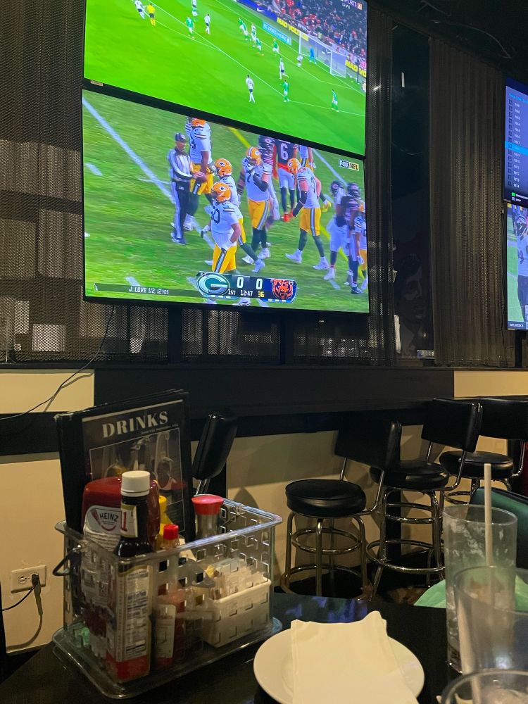 TV in bar with the Green Bay Packers playing 