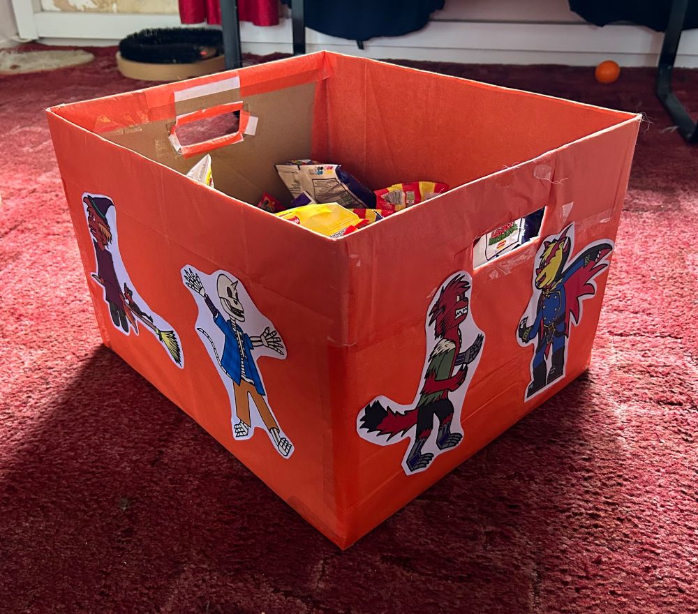 The other side of the box. The drawings are more anthropomorphic characters dressed as a witch, skeleton, werewolf and vampire.
