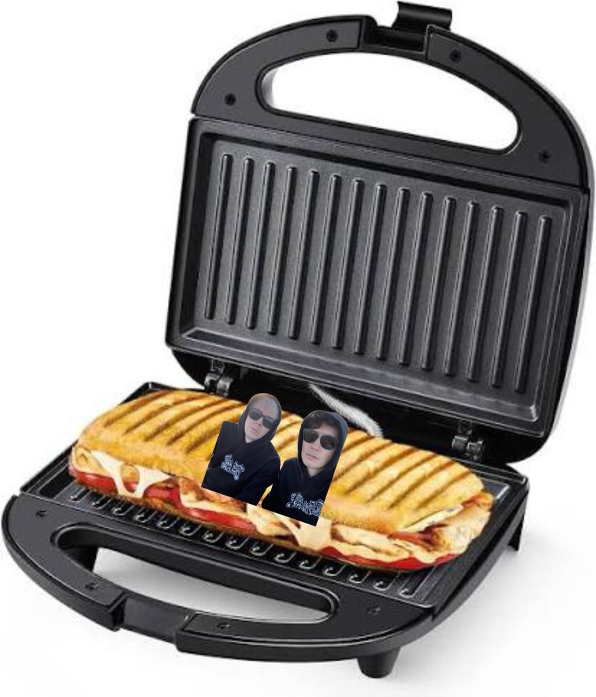 A panini on a panini press with a picture of Dan and phil in their tit hoodies edited in