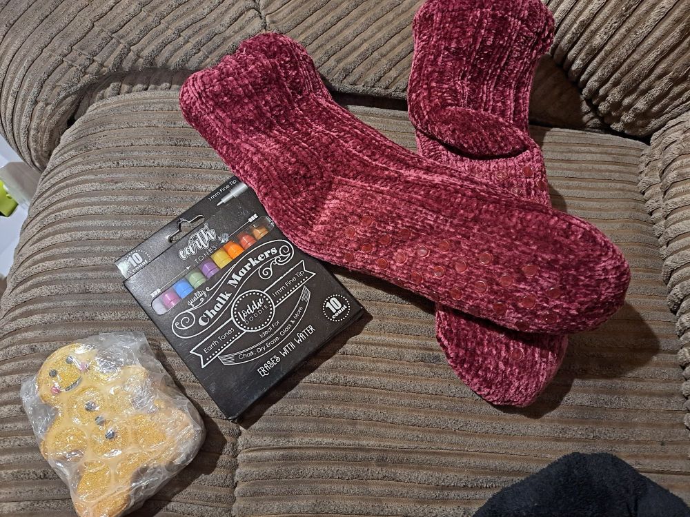 Some twanta gifts throughout the years, this pic shows soft thick red socks a gingerbread man shaped bath bomb, and some chalk markers