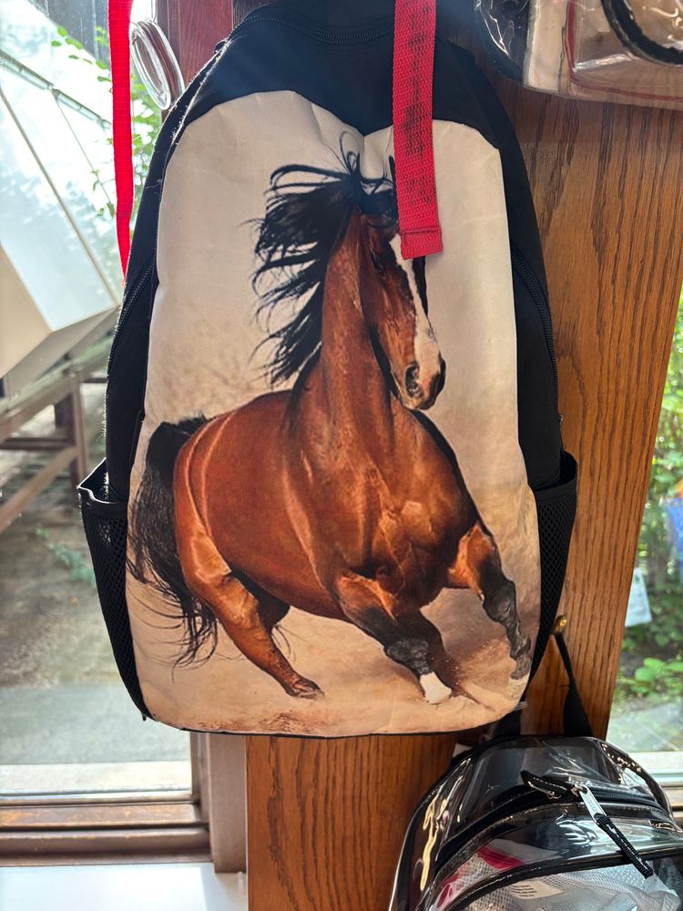 A backpack with a stock image of a horse, the same as used by the horse_ebooks account on twitter 